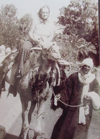 Pauline Riding a Camel in the Middle East